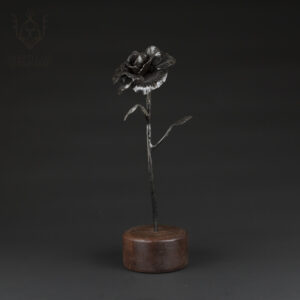 Forged rose standing in wood