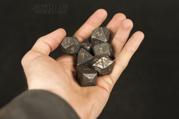 forged steel dnd dice in hand