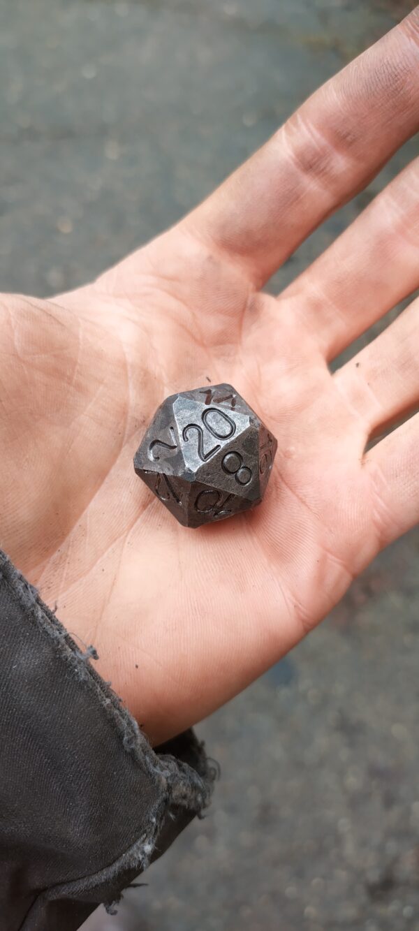 steel d20 in hand