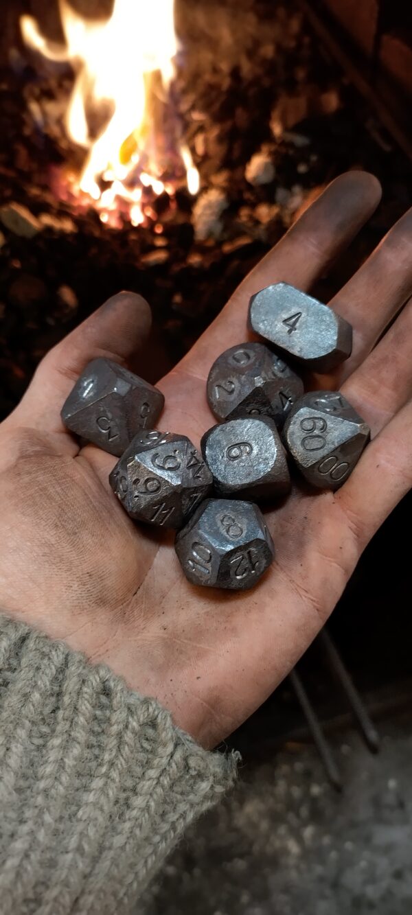 steel Dnd dice set held in han