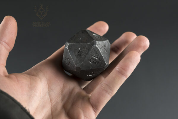 chunky steel d20 in hand